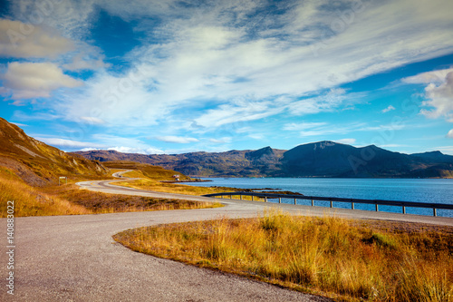 Fjord with cloudy blye sky. Rocky shore. Beautiful nature Norway. Mageroya island