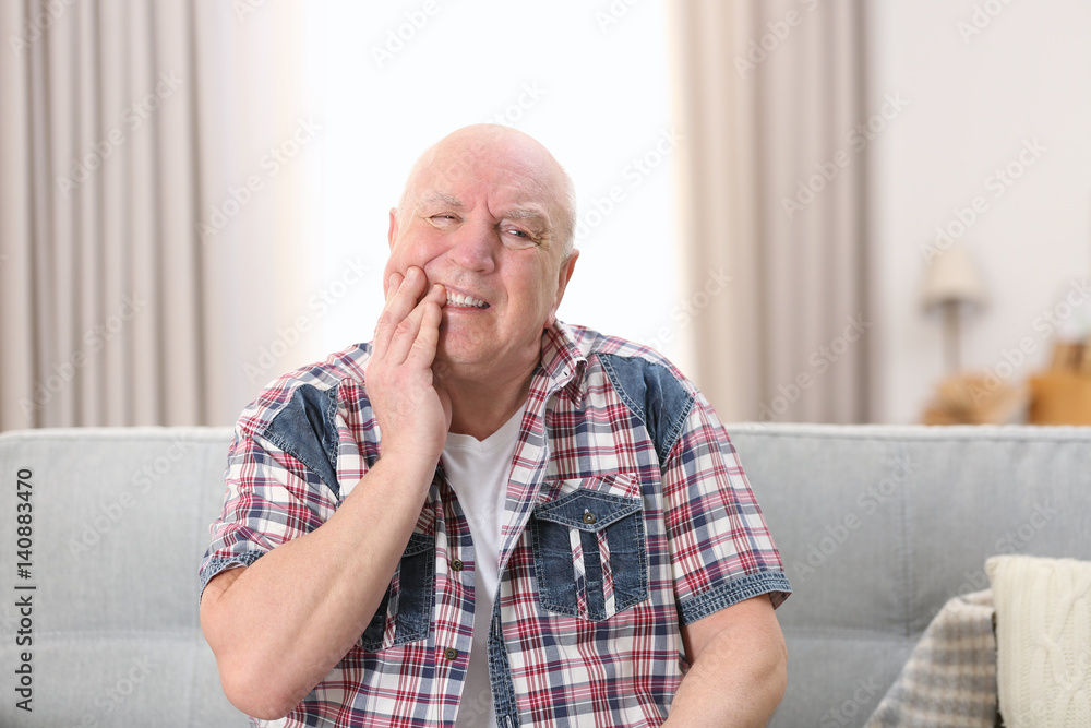 Mature man suffering from pain at home Mature man suffering from pain at home