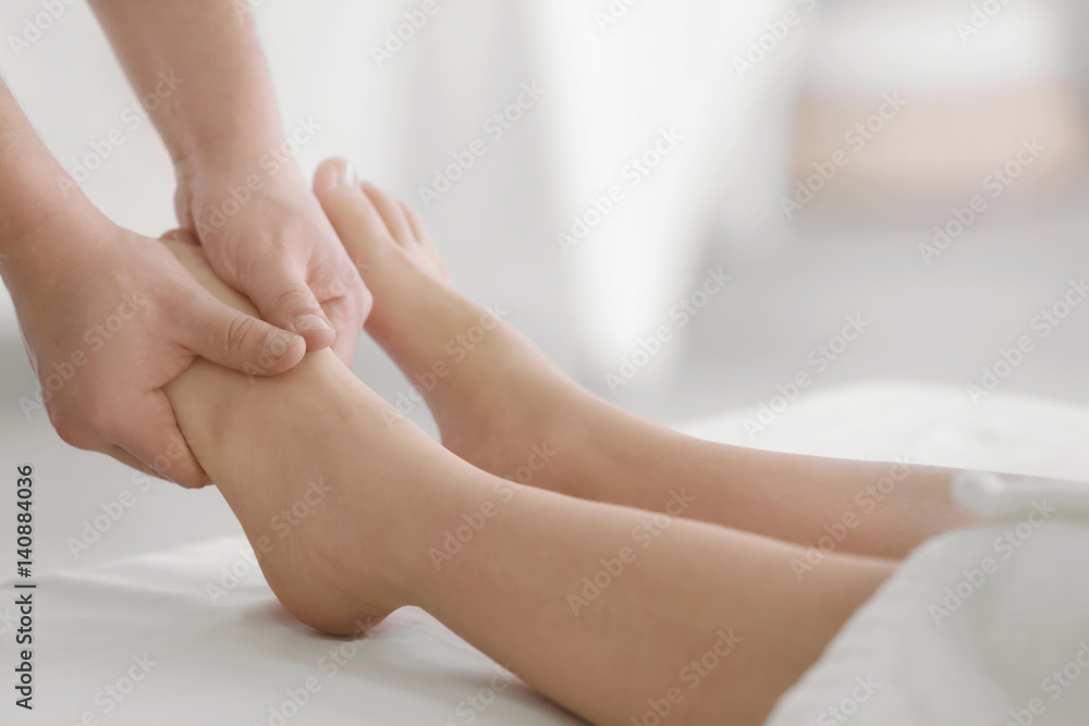 Young woman receiving foot massage in spa salon Young woman receiving foot massage in spa salon