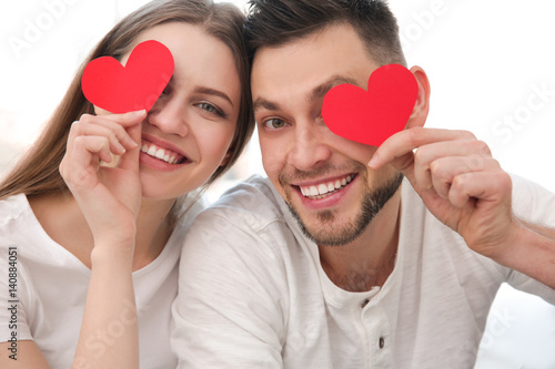 Happy young couple with red...