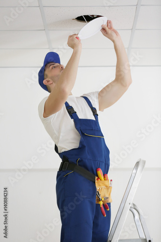 Electrician repairing ceili...
