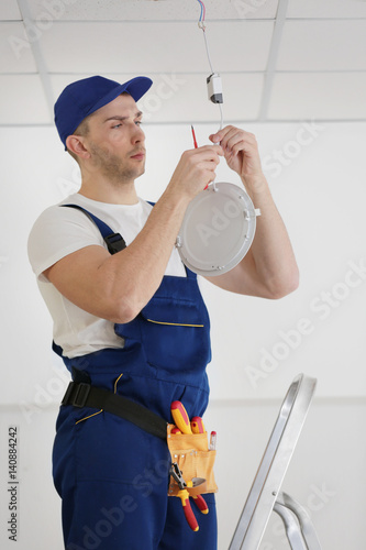 Electrician repairing ceili...