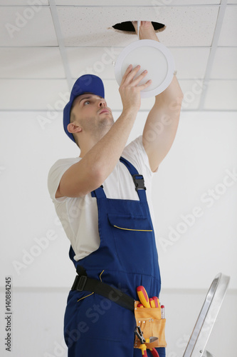 Electrician repairing ceili...