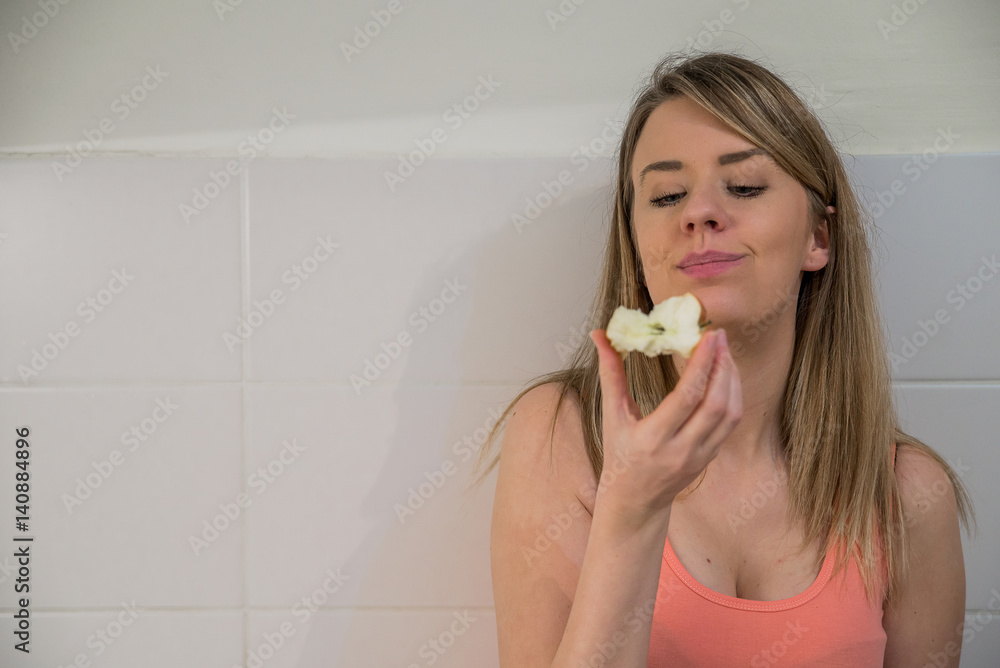 young pretty brunette girl eating apple isolated on white, Happy young woman eating apples on kitchen young pretty brunette girl eating apple isolated on white, Happy young woman eating apples on kitchen