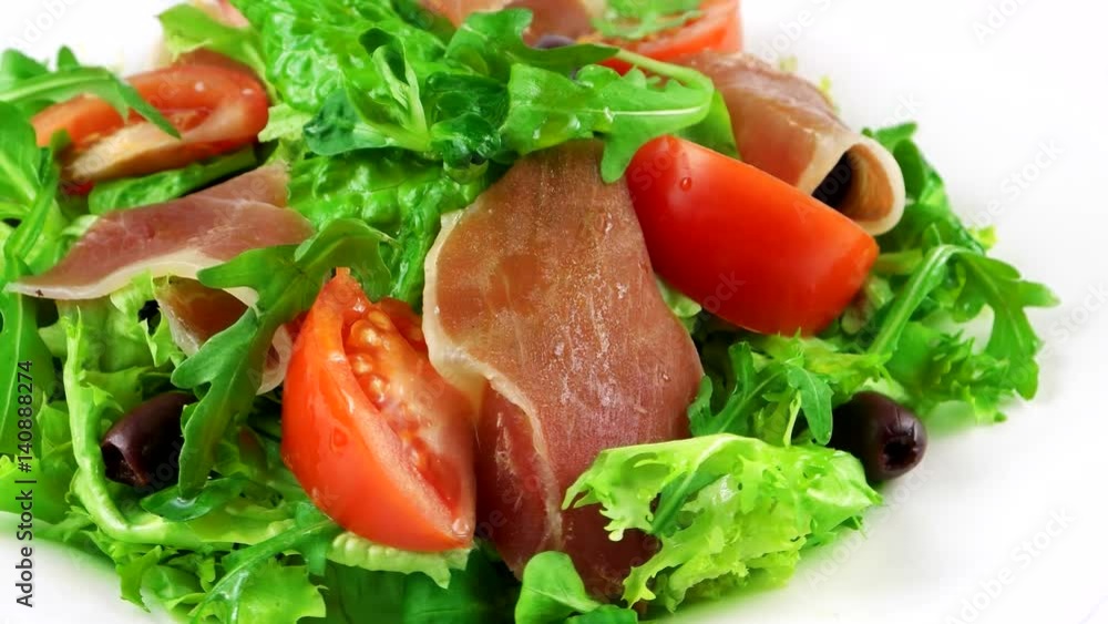 Restaurant salad with Hamon, lettuce leaf, arugula, tomatoes and olives, loop
Restaurant salad with Hamon, lettuce leaf, arugula, tomatoes and olives, loop