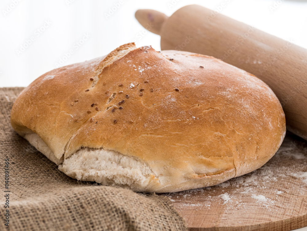 Round bun bread with a rolling pin