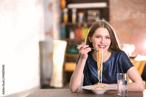 Beautiful woman eating past...