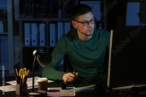 Young male designer working...