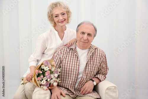 Happy senior couple with fl...