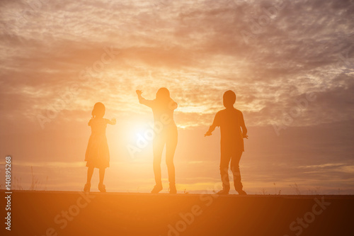 Brother and brother silhouette,Moments of the child's joy. On the Nature sunset