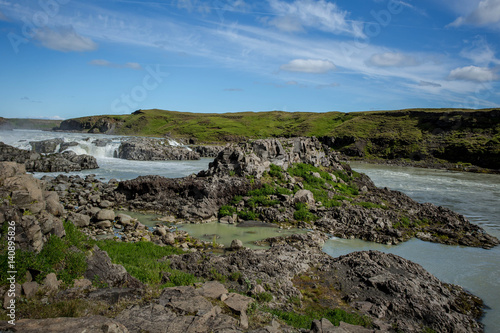 Green valley with river and waterfall. Icelandic landscape.