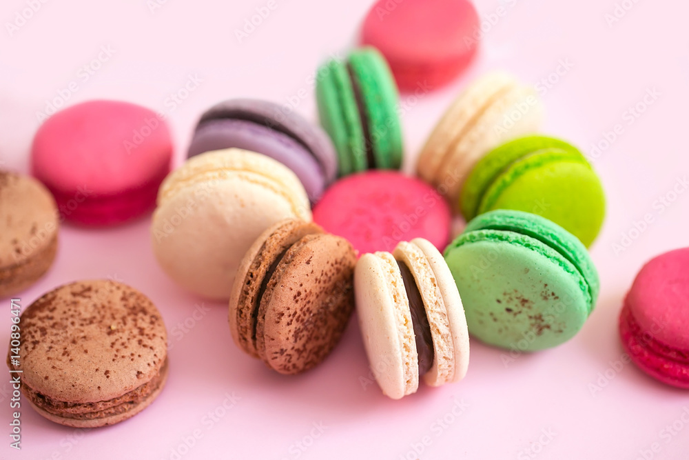 Multicolored macaroon cookies on a pink background Multicolored macaroon cookies on a pink background