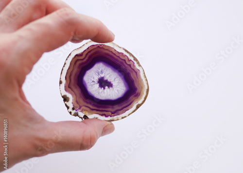 Purple slice of agate. Natural agate closeup isolated on white background.