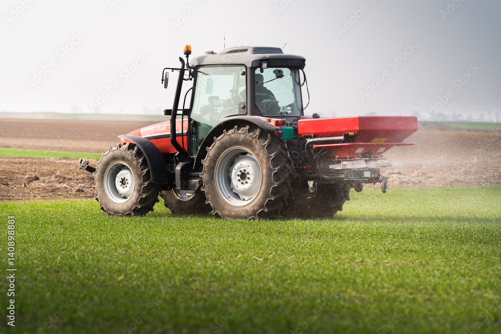Tractor spreading artificial fertilizers Tractor spreading artificial fertilizers