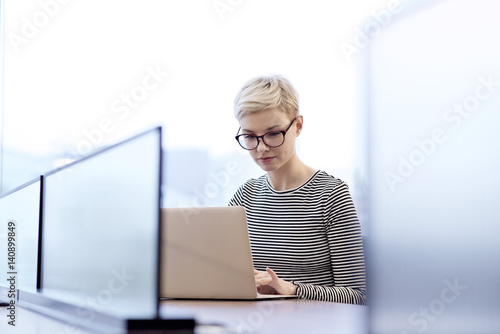 Young woman using laptop in office