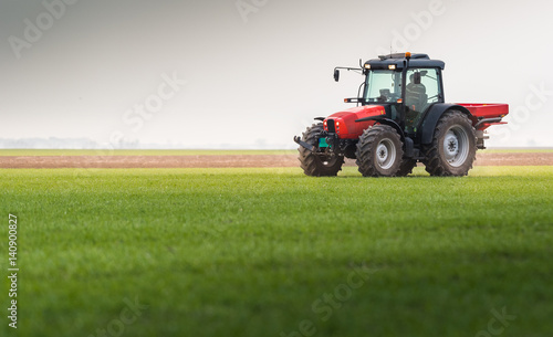 Tractor spreading artificial fertilizers