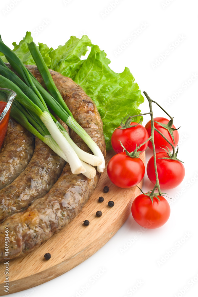 Sausages homemade with vegetables, tomato and green onions
