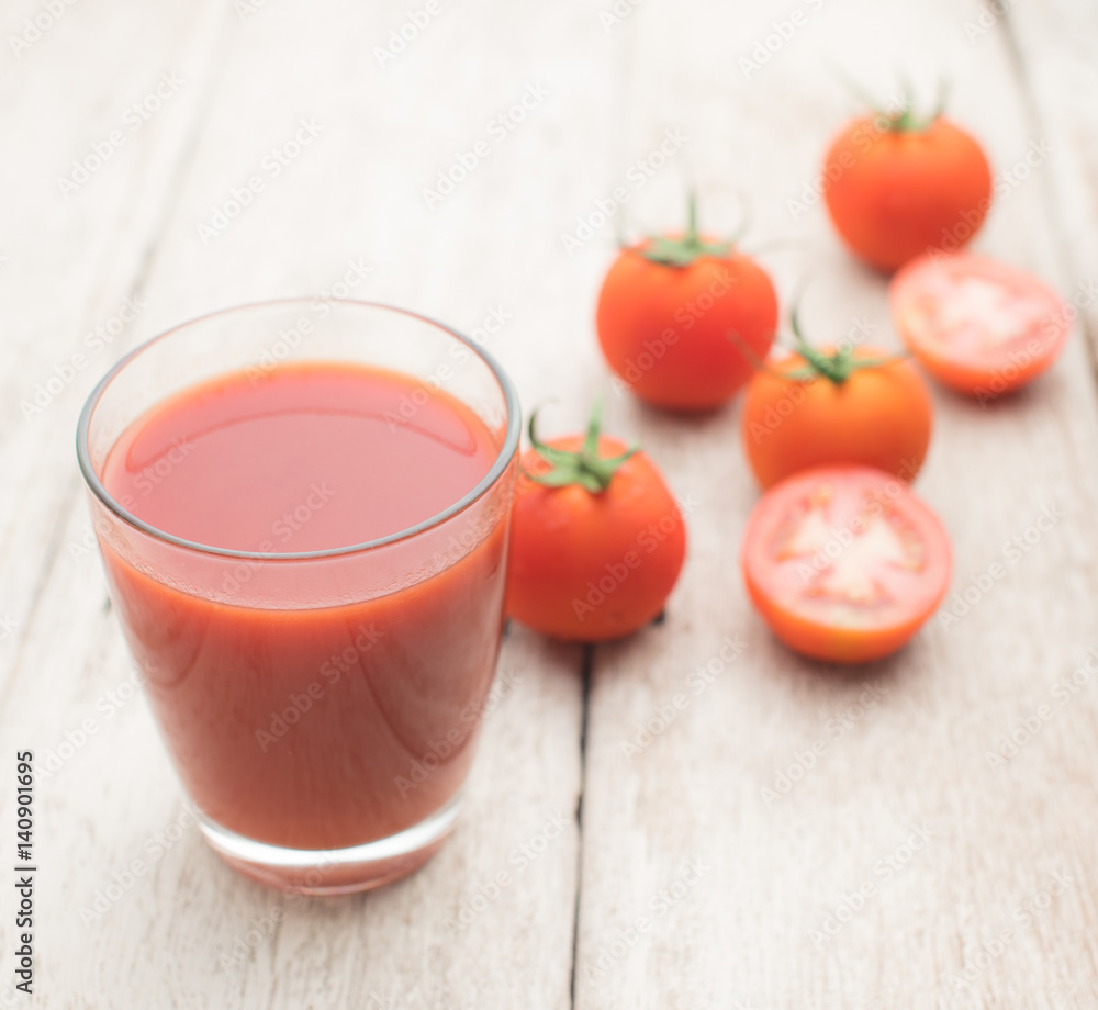 Glass of tomato juice on wooden table Glass of tomato juice on wooden table