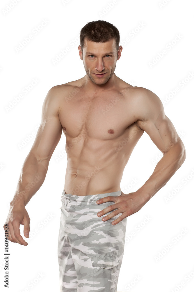 half-naked handsome and muscular young man posing on a white background half-naked handsome and muscular young man posing on a white background