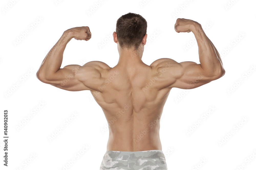 rear view of the half-naked handsome and muscular young man posing on a white background