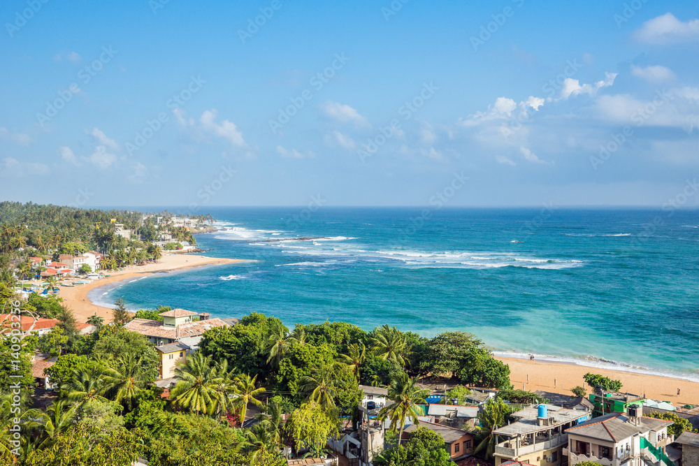Unawatuna beach at sunny day. Panoramic view from rooftop hotel.