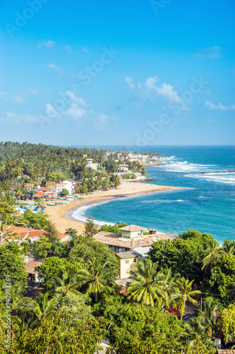 Unawatuna beach at sunny day. View from rooftop hotel.