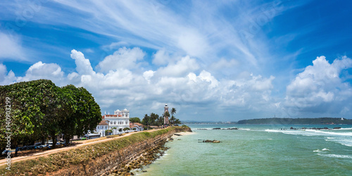 White lighthouse and Meeran Jumma Masjid mosque in old Dutch Galle fort, Sri Lanka in sunny day photo