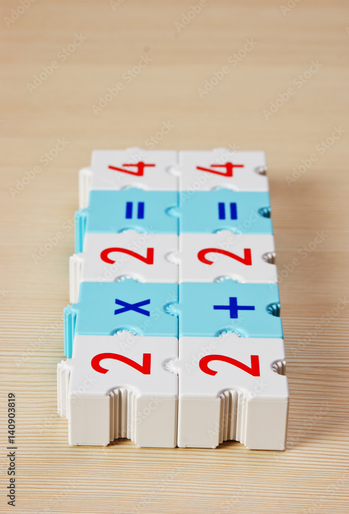 Educational blocks with math problems on the table Educational blocks with math problems on the table