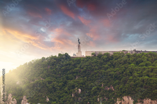Statue of Liberty, Gellert hill, Budapest, Hungary. Panorama of the city with a statue on the horizon photo