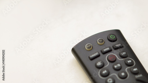 a TV remote on a white background 