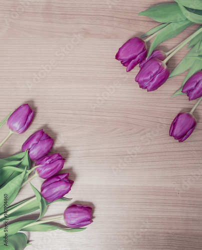 Tulips lying on a wooden background