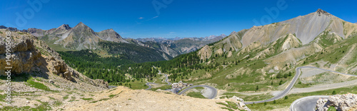 Spectacular view of the French Alps, Napoleon mountain lodge and a winding road