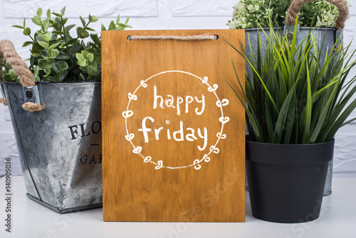 Wooden board with text happy friday