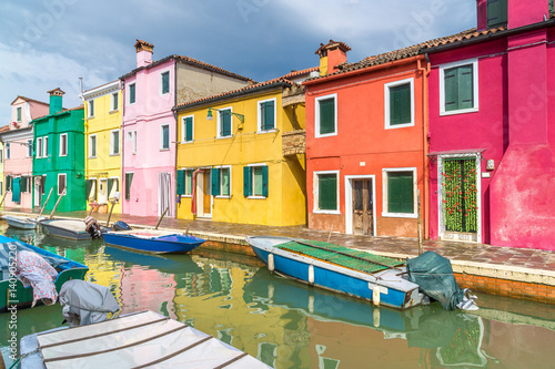 Colorful houses on Burano. A typical street and canal on the island of Burano near Venice.