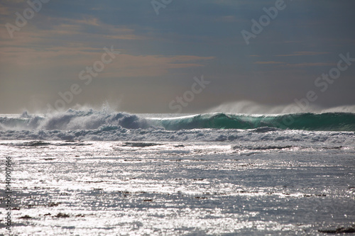 Ocean waves close up and the sparkle of water at sunset