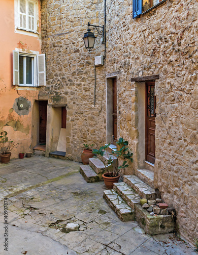 Patio with flowers in the old town Coaraze in France photo