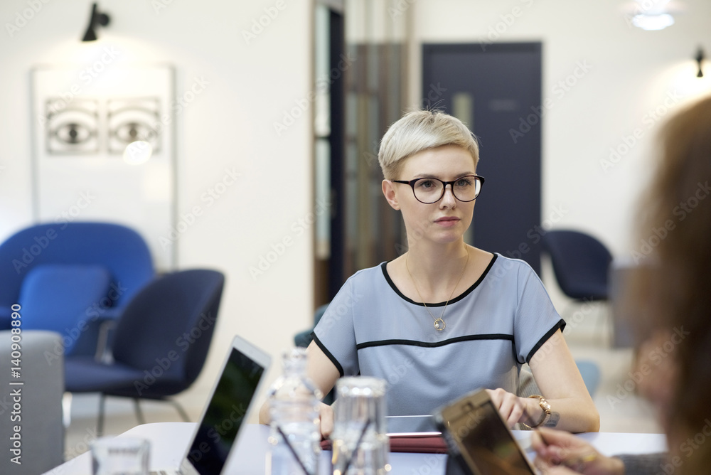 Young caucasian businesswoman in a team meeting Young caucasian businesswoman in a team meeting