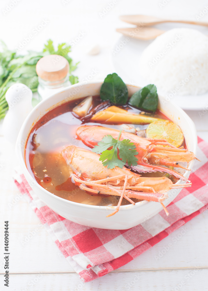 Tom Yam Kung (Thai cuisine) with rice on table wooden Tom Yam Kung (Thai cuisine) with rice on table wooden