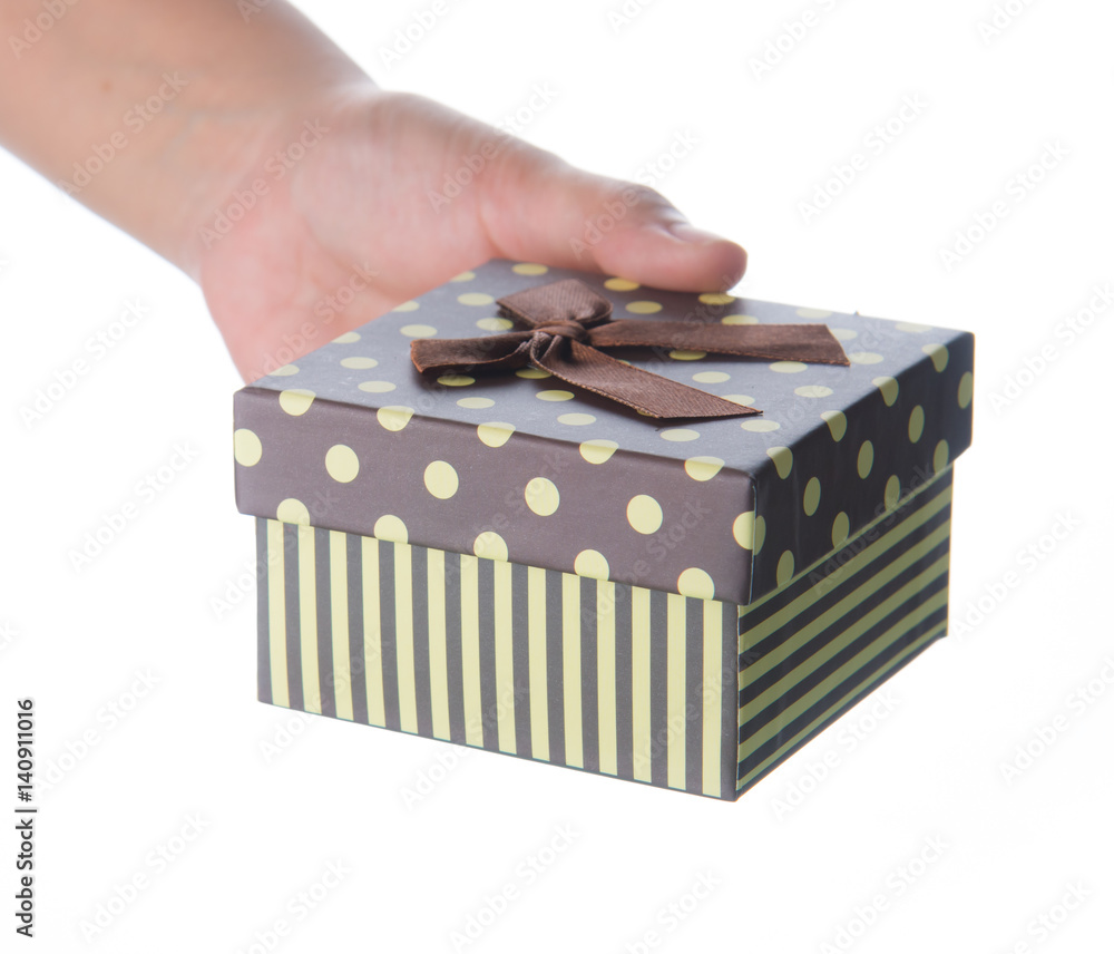 Obraz premium Hand holding small box for a gift isolated on white