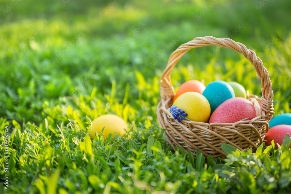 Fototapeta premium Happy Easter. Colorful Easter eggs in a basket. Easter background with copyspace