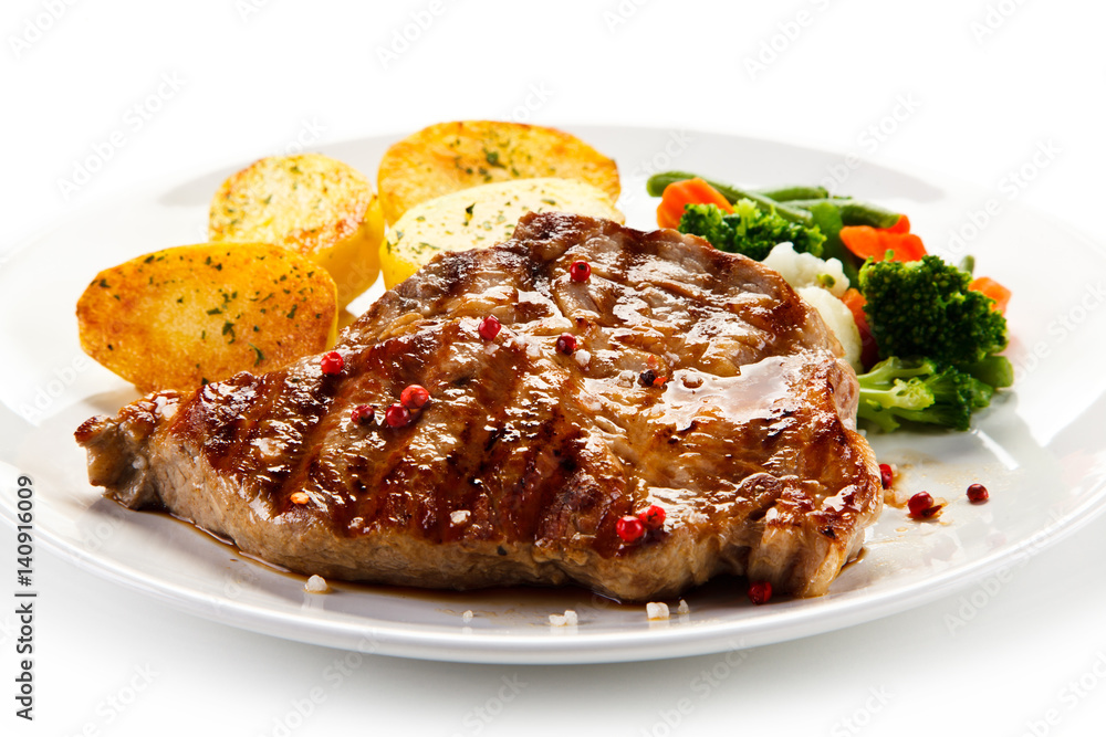 Steaks, baked potatoes and vegetable salad Steaks, baked potatoes and vegetable salad