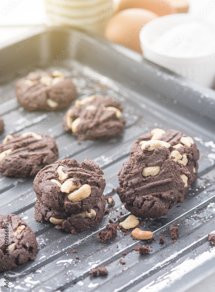 Fototapeta premium Delicious chocolate cookies with nuts on a baking tray