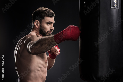 Boxer with punching bag © LIGHTFIELD STUDIOS