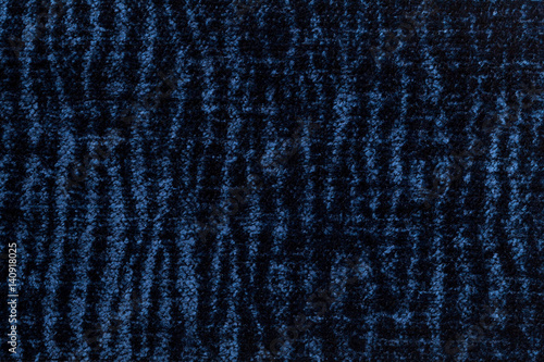 Dark blue fluffy background of soft, fleecy cloth. Texture of textile closeup