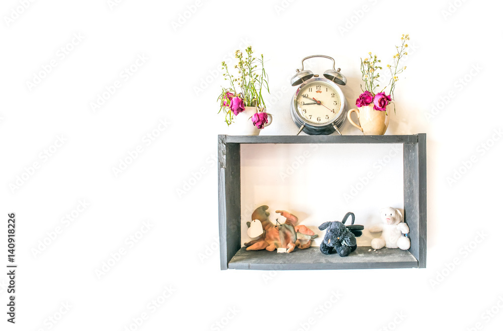 Obraz premium small doll and clock with flower pot decoration on wood frame isolated white background 