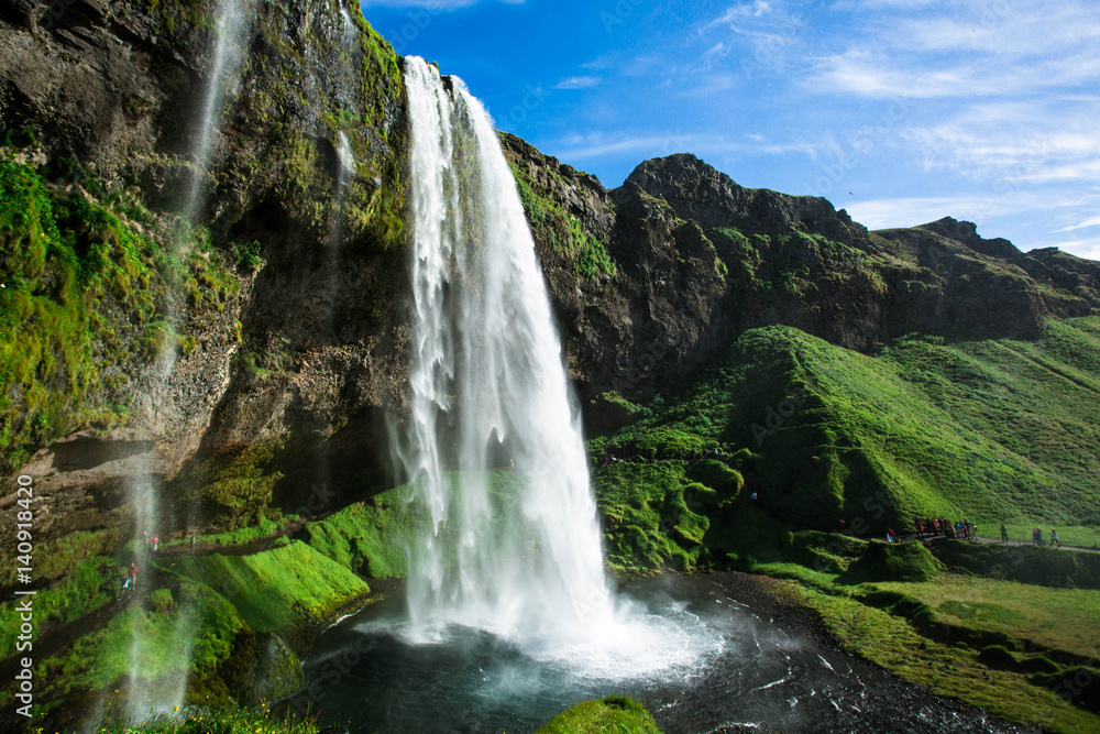 Famous waterfall Seljalandsfoss in the summer, Iceland. Famous waterfall Seljalandsfoss in the summer, Iceland.