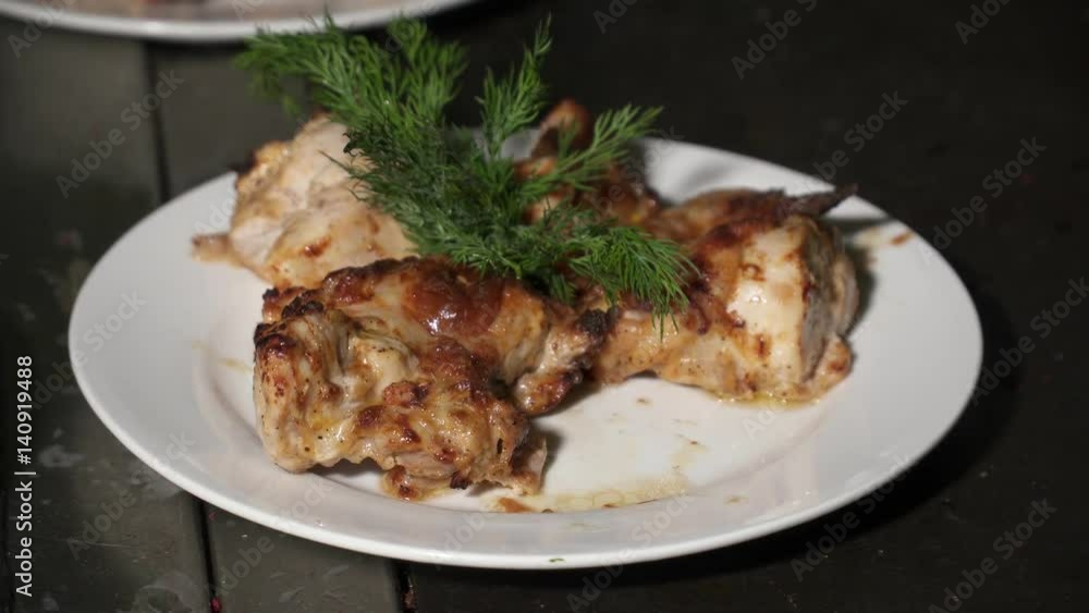 Chef adding fresh dill to the fried chicken Chef adding fresh dill to the fried chicken