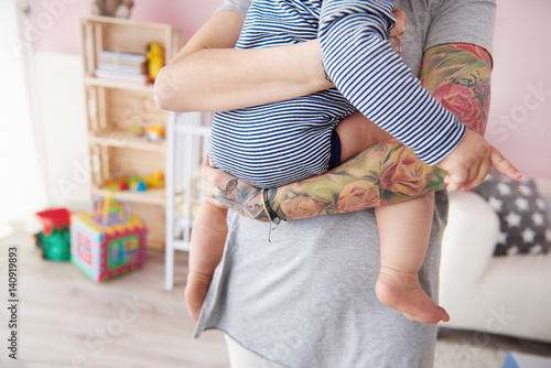 Hipster mother with baby holding in arms © gpointstudio