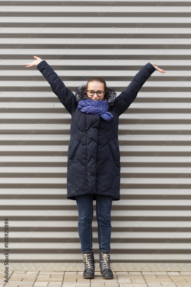 Beautiful girl on a striped wall background Beautiful girl on a striped wall background