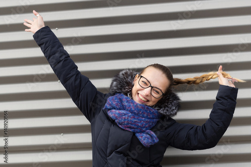 Beautiful girl on a striped wall background